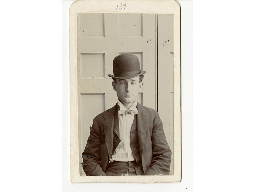 An old photograph of a man wearing a bolo hat and a bowtie